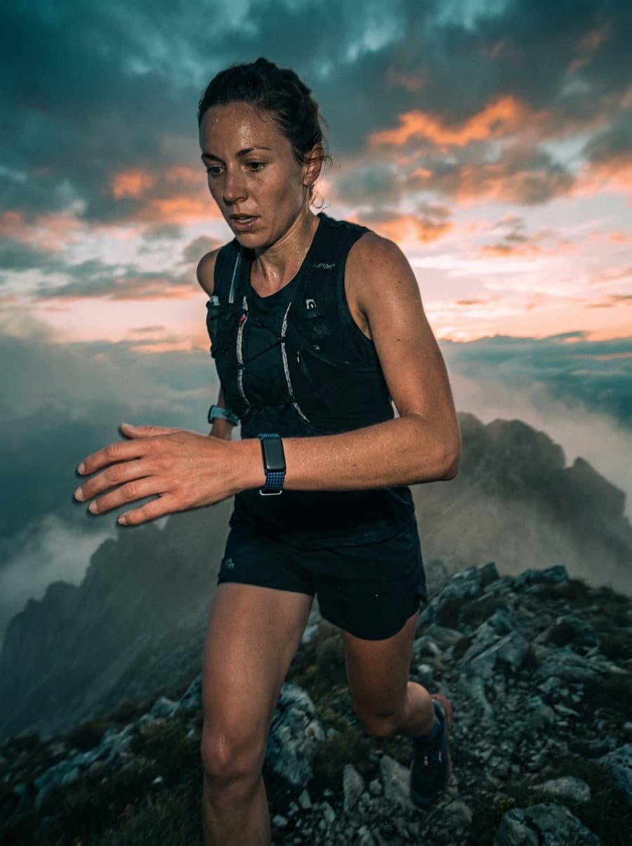 A trail runner at dawn wearing the BEFORE Band